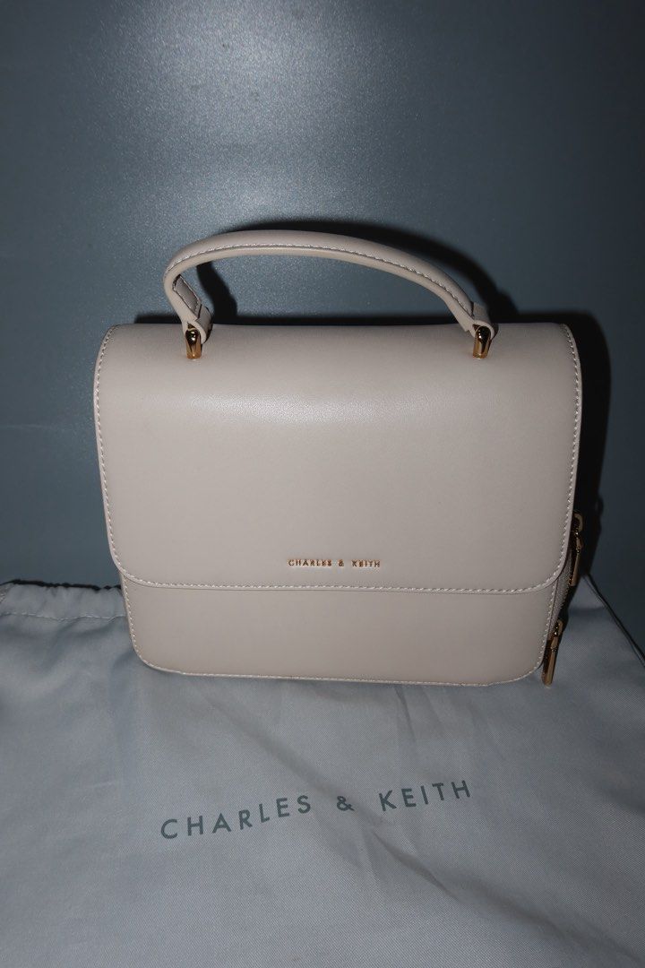 Charles & Keith Cream Top Handle Bag (Category: Shoulder Bags) located in General Trias. Submitted by laiyieeeee (Listing ID 1469011016, Image 3). Description: - Brand: Charles & Keith - Style: Structured top handle bag - Color: Versatile neutral cream - Details: Chic gold-tone hardware and side gusset zip closure - Condition: Clean exterior and interior compartments - Inclusions: Matching branded dust bag - USED ONCE.