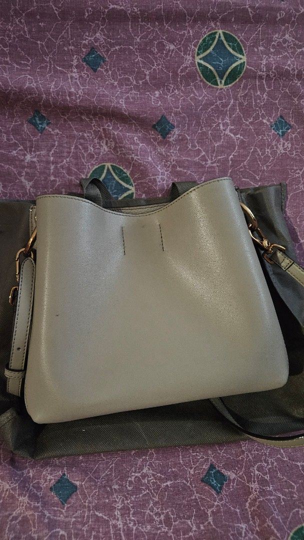 Charles & Keith Taupe Sling Bag (Category: Shoulder Bags) located in Pasig City. Submitted by samjavxx (Listing ID 1469093788, Image 3). Description: Bought in 2019 only used once. Minor signs of leather aging as seen in pictures Buyer to shoulder delivery via grab/lalamove, pick up point in Ortigas area Pasig - Brand: Charles & Keith - Style: Structured shoulder bag in muted green with gold-tone hardware - Closure: Secure lock closure on front f