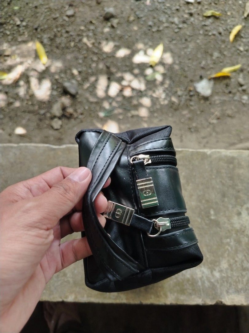 Christian Dior Black Toiletry Bag (Category: Luxury Bags & Wallets) located in Caloocan City. Submitted by vincefresn21903 (Listing ID 1468955715, Image 1). Description: Black Christian Dior pouch with dual zippered compartments. Sturdy nylon and faux leather material. Compact size for daily essentials or travel gear. Debossed Dior logo on the front panel. Wrist strap attached on the side. Silver tone hardware zippers work smoothly..