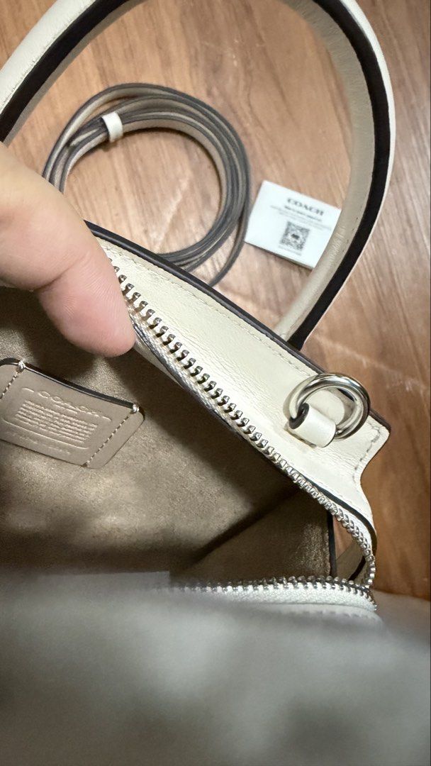 Coach Andrea Mini Carryall Bag (Category: Luxury Bags & Wallets) located in Valenzuela. Submitted by ruichi080607 (Listing ID 1468983475, Image 3). Description: -bought for 22k - Authentic Coach mini tote in crisp white leather with sleek silver hardware - Secure zip-top closure to keep your essentials safe - Versatile design with dual top handles and a detachable crossbody strap - Clean interior featuring a fabric lining and official Coach creed