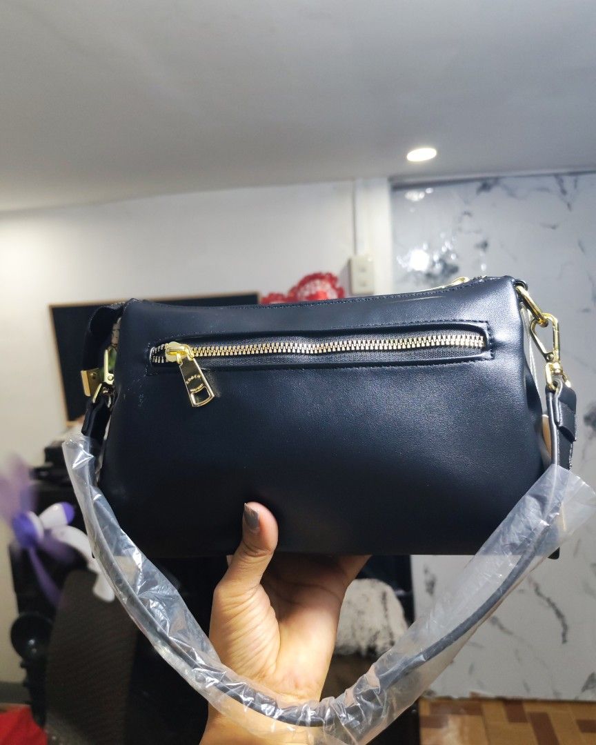 Coach Black Shoulder Bag with Gold Hardware (Category: Luxury Bags & Wallets) located in Caloocan City. Submitted by miyaka_lm (Listing ID 1469078651, Image 2). Description: - Brand new with tags still attached - Sleek black shoulder bag made from smooth material - Elegant gold-tone hardware and chain details - Straps still wrapped in protective plastic - Secure zippered compartments + external back zip pocket - Chic patterned fabric lining with 