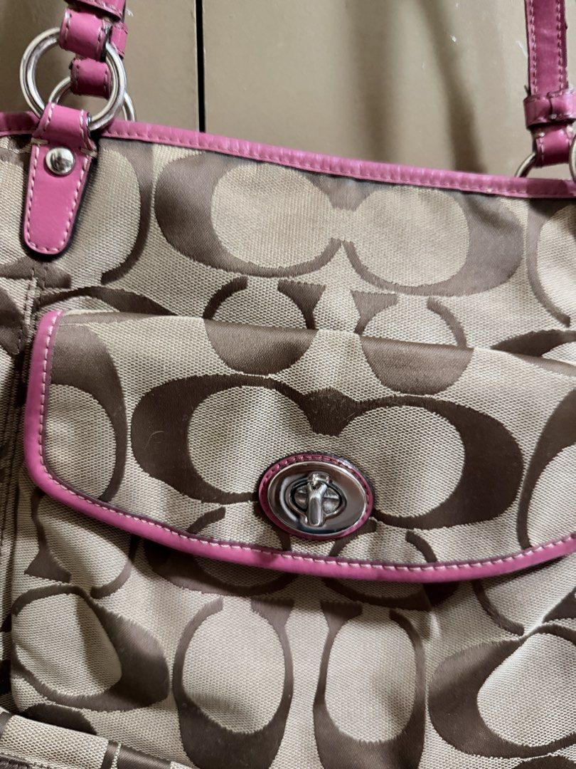 Coach Brown Pink Shoulder Bag (Category: Shoulder Bags) located in Quezon City. Submitted by labyrinthine.ph (Listing ID 1469063577, Image 3). Description: - Authentic Coach tote bag in khaki signature C jacquard fabric with pink leather trim - Features a front flap pocket with a secure turnlock closure and iconic pink hangtag - Convenient and secure top zip closure for daily essentials - Flaws to note: Visible cracking and wear along the handle 