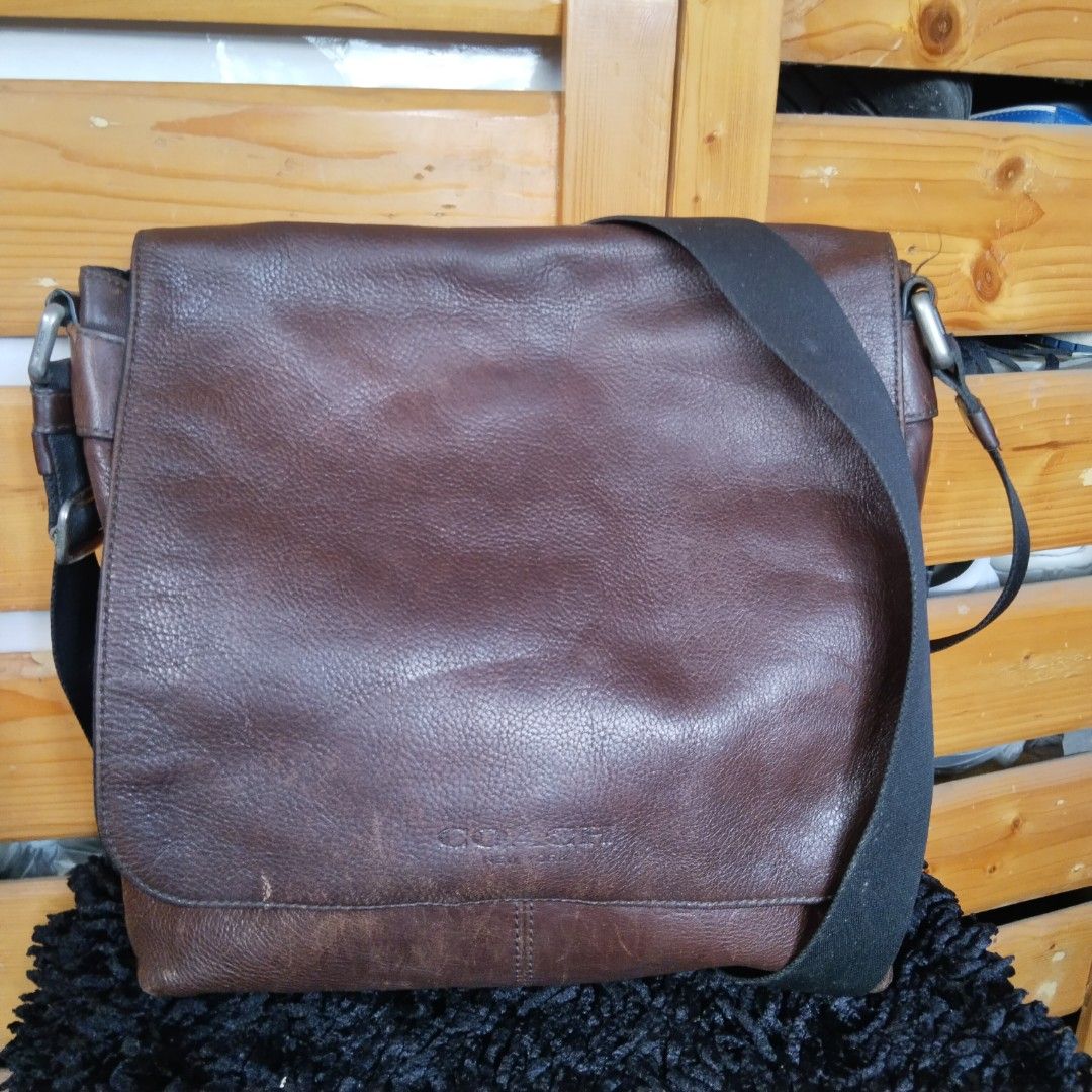 Coach Dark Brown Leather Messenger Bag (Category: Luxury Bags & Wallets) located in Lubao. Submitted by dione_closet503 (Listing ID 1469075580, Image 1). Description: - Authentic Coach messenger bag in dark brown leather - Durable heavy-duty build with solid stitching - Adjustable black fabric strap with sleek metal hardware - Classic embossed Coach logo on the front flap - Spacious main compartment under the flap for your daily essentials - Cond