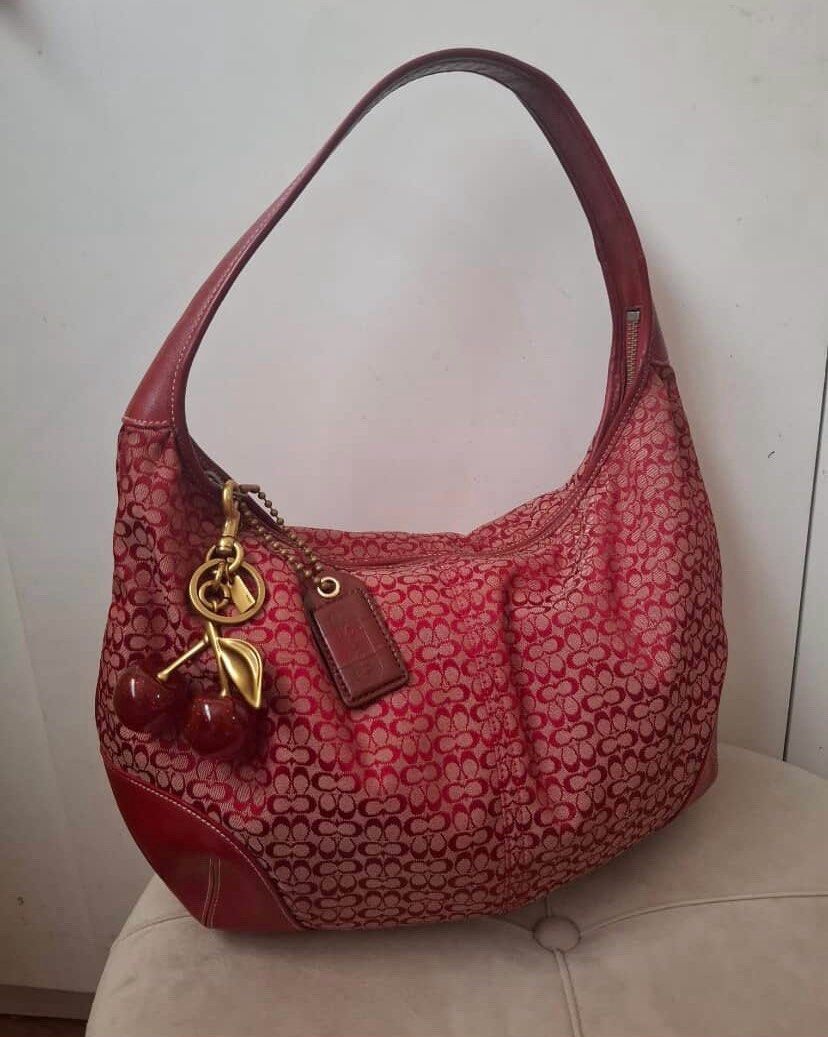 Coach Ergo Red Vintage Bag (Category: Shoulder Bags) located in Muntinlupa City. Submitted by lovefrenzie (Listing ID 1469067731, Image 1). Description: Rare Red Canvas bag Cherry Charm not included With Signs of use Issue: Hiwa sa bawat gilid ng lips pero matibay ang tahi ng canvas at malinis ang leather at canvas. Repainted ang ilalim ng strap pero mas bumagay sa bag since yellow ang orig color ng strap sa ilalim. NEGOTIABLE. Please make an off
