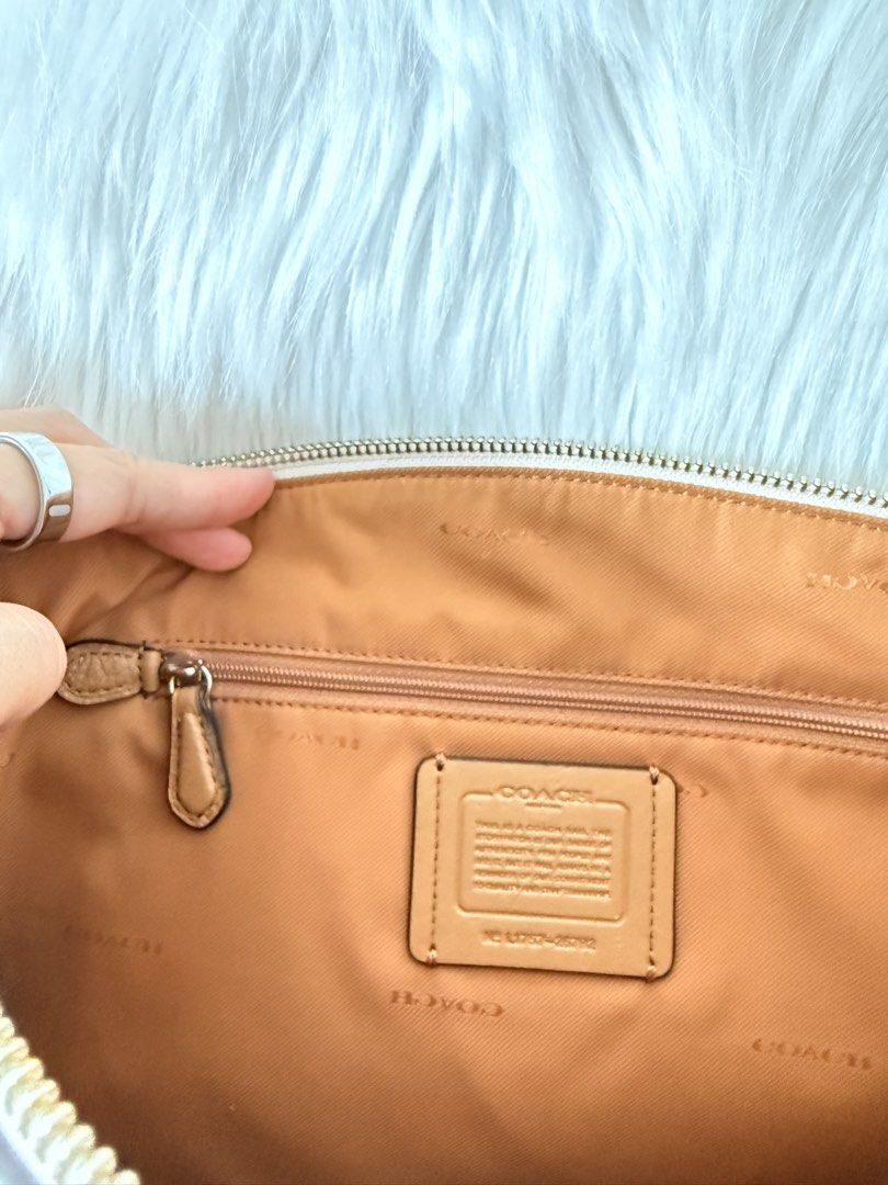 Coach Floral Print Satchel Handbag (Category: Luxury Bags & Wallets) located in Cainta. Submitted by mskath__ (Listing ID 1469010902, Image 3). Description: - Authentic Coach satchel in cream leather with floral print - Tan leather handles, detachable strap, and matching hangtag - Silver-tone hardware and secure zip-top closure - Exterior front zip pocket with Coach logo lettering - Clean tan fabric interior with an inner zip pocket - Well-mainta