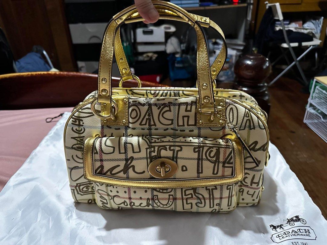 Coach Graffiti Plaid Satchel Handbag (Category: Luxury Bags & Wallets) located in Quezon City. Submitted by chloesantiago (Listing ID 1468963962, Image 1). Description: - Brand: Coach - Style: Graffiti plaid satchel handbag - Trim & Handles: Metallic gold leather - Hardware: Gold accents - Pockets: Front pocket with secure turn-lock closure - Inclusions: Original white Coach Leatherware dust bag - Condition: Classic structured design, well-mainta