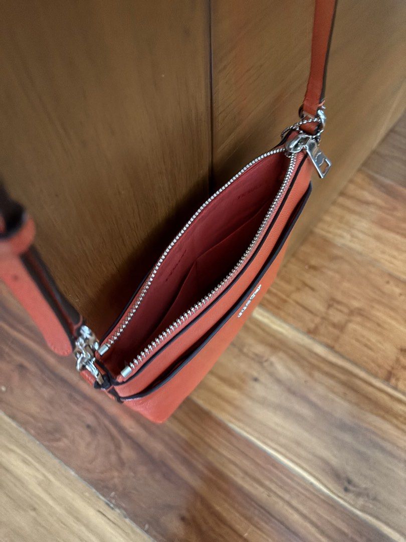 Coach Kitt Messenger Crossbody Bag (Category: Cross-body Bags) located in Quezon City. Submitted by shannon.59 (Listing ID 1468990196, Image 3). Description: • Material: Scratch-resistant, durable crossgrain leather. • Design: A sleek, slim silhouette featuring a secure top-zip closure, a convenient front exterior slip pocket, and the classic Coach metallic lettering logo on the front. • Strap: Detachable and adjustable long leather strap designe