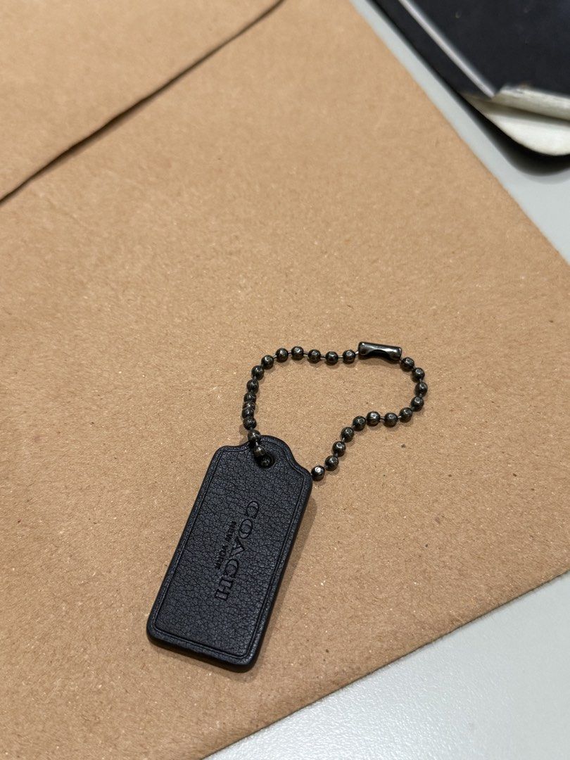Coach Leather Hangtag (Category: Purses & Pouches) located in Caloocan City. Submitted by tokyo112419 (Listing ID 1468940676, Image 2). Description: Authentic black leather Coach hangtag with gunmetal chain. Clean stitching and hardware. Perfect as a bag replacement or collector's piece..