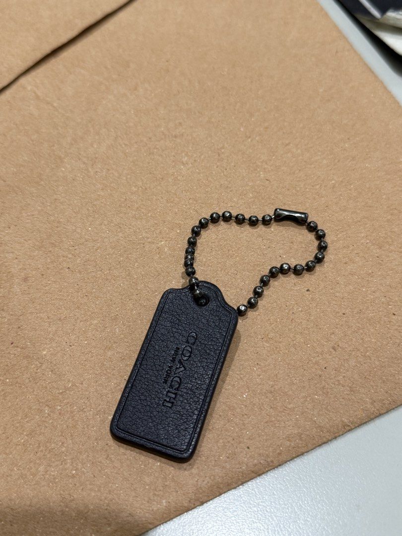 Coach Leather Hangtag (Category: Purses & Pouches) located in Caloocan City. Submitted by tokyo112419 (Listing ID 1468940676, Image 1). Description: Authentic black leather Coach hangtag with gunmetal chain. Clean stitching and hardware. Perfect as a bag replacement or collector's piece..
