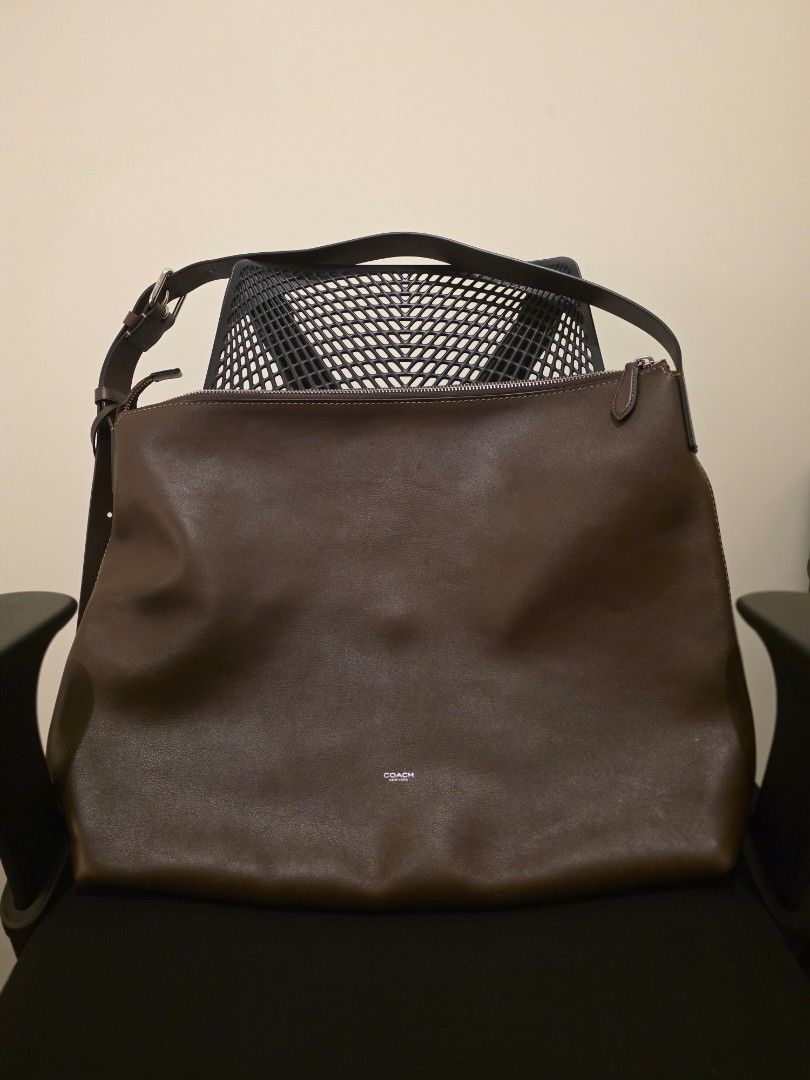 Coach Mens Mott Messenger Bag (Category: Luxury Bags & Wallets) located in Makati City. Submitted by coolbeansyeah (Listing ID 1469099431, Image 2). Description: - Brand: Coach - Color: Deep chocolate brown - Material: Genuine leather - Style: Everyday slouchy shoulder bag - Closure: Top zipper - Strap: Adjustable with buckle - Interior: Clean lining with minimal hardware accents - Capacity: Perfect for daily essentials (phone, wallet, keys, smal