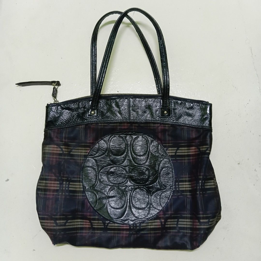Coach Plaid Tote Bag Black Plaid Pattern (Category: Tote Bags) located in Manila. Submitted by daphnefinds1 (Listing ID 1469054374, Image 1). Description: - Authentic Coach tote bag in a stylish dark plaid pattern - Glossy black trim and dual comfortable shoulder straps - Signature embossed Coach logo patch on the front - Secure zipper closure with a leather pull tab - Roomy interior, perfect for daily essentials - Condition: Shows minor fabric w
