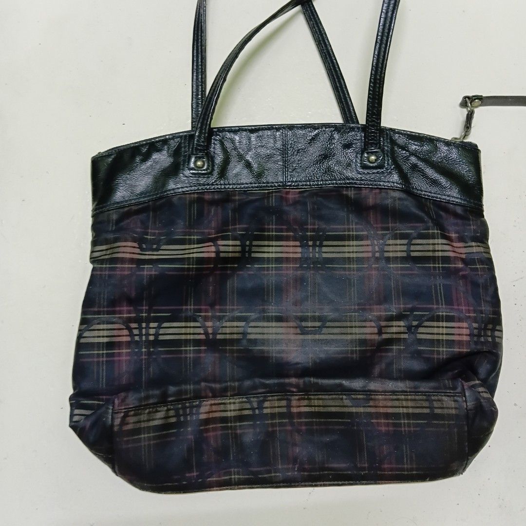 Coach Plaid Tote Bag Black Plaid Pattern (Category: Tote Bags) located in Manila. Submitted by daphnefinds1 (Listing ID 1469054374, Image 3). Description: - Authentic Coach tote bag in a stylish dark plaid pattern - Glossy black trim and dual comfortable shoulder straps - Signature embossed Coach logo patch on the front - Secure zipper closure with a leather pull tab - Roomy interior, perfect for daily essentials - Condition: Shows minor fabric w