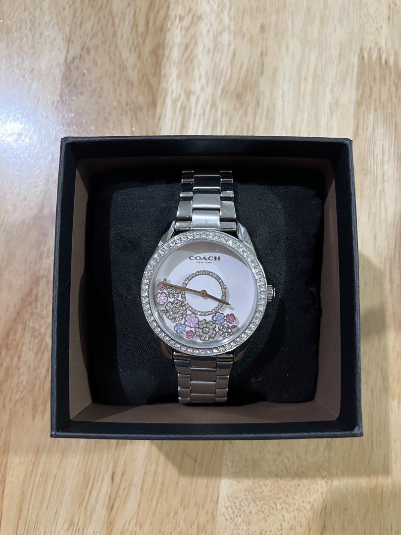 Coach Preston Crystal Accent Watch (Category: Luxury Accessories) located in San Pedro. Submitted by jeikei08 (Listing ID 1469114081, Image 2). Description: • Brand: Coach (Preston Collection) • Model Number: 14503775 • Case Size: 36 mm • Case Material: Stainless steel with crystal-accented bezel • Dial: White sunray dial featuring prairie-inspired crystal floral and circular floating/moving accents • Movement: Quartz • Water Resistance: 3 ATM / 