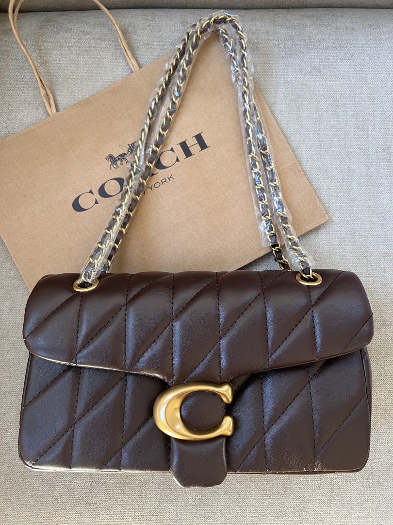Coach Quilted Pillow Tabby Shoulder Bag (Category: Luxury Bags & Wallets) located in Manila. Submitted by orsaljoce25536 (Listing ID 1469080363, Image 1). Description: - Brand new Coach quilted shoulder bag with luxurious diagonal stitching - Features the iconic signature C clasp closure and a stylish chain strap - Colors available: Dark Brown, Black, White, and Soft Pink - Straps are securely wrapped in protective plastic for your assurance - In