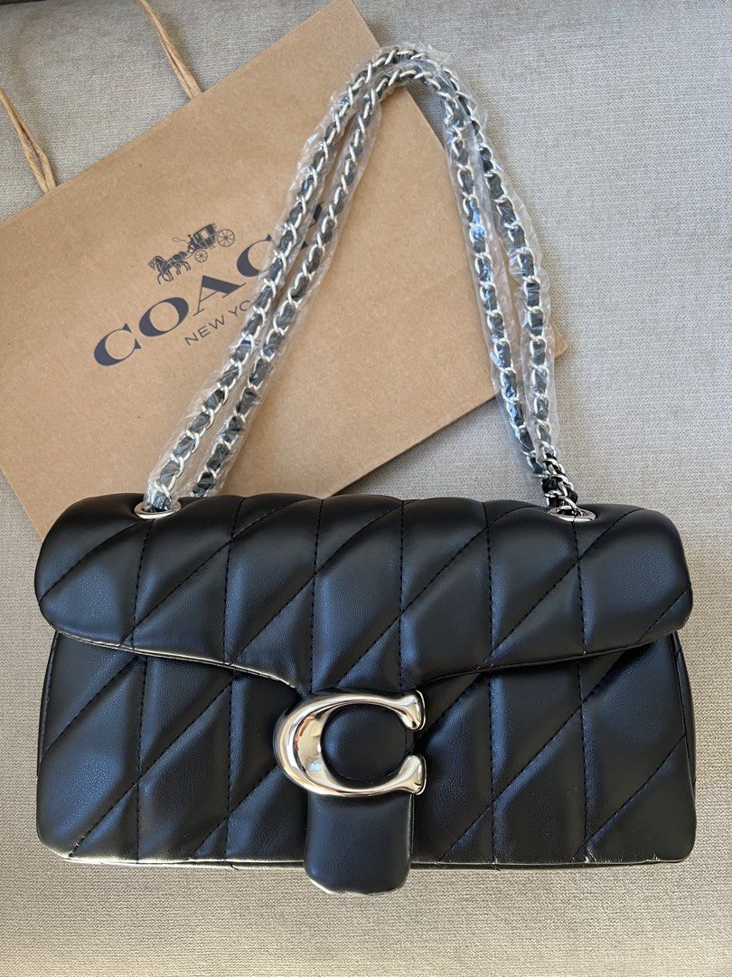 Coach Quilted Pillow Tabby Shoulder Bag (Category: Luxury Bags & Wallets) located in Manila. Submitted by orsaljoce25536 (Listing ID 1469080363, Image 3). Description: - Brand new Coach quilted shoulder bag with luxurious diagonal stitching - Features the iconic signature C clasp closure and a stylish chain strap - Colors available: Dark Brown, Black, White, and Soft Pink - Straps are securely wrapped in protective plastic for your assurance - In