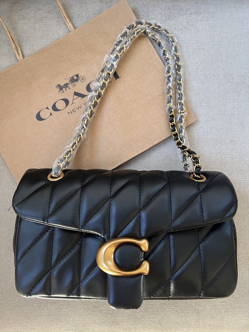 Coach Quilted Pillow Tabby Shoulder Bag (Category: Luxury Bags & Wallets) located in Manila. Submitted by orsaljoce25536 (Listing ID 1469080363, Image 2). Description: - Brand new Coach quilted shoulder bag with luxurious diagonal stitching - Features the iconic signature C clasp closure and a stylish chain strap - Colors available: Dark Brown, Black, White, and Soft Pink - Straps are securely wrapped in protective plastic for your assurance - In