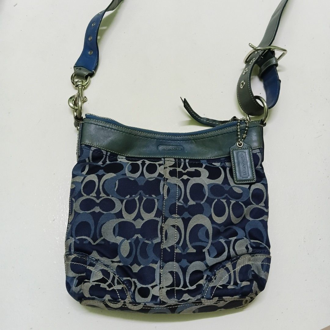 Coach Signature Blue Monogram Shoulder Bag (Category: Shoulder Bags) located in Manila. Submitted by daphnefinds1 (Listing ID 1469054315, Image 1). Description: - Authentic Coach monogram shoulder bag in blue and grey - Premium dark teal leather trim and strap with buckle details - Polished silver-tone hardware and secure zip closures - Dark blue fabric-lined interior featuring a zipper pocket and slip pockets - Includes signature matching hangta