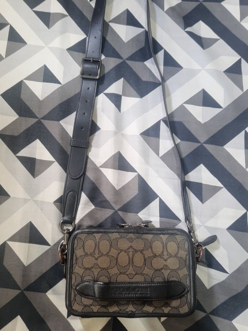 Coach Signature Monogram Crossbody Bag (Category: Luxury Bags & Wallets) located in Manila. Submitted by xter_92 (Listing ID 1468947621, Image 1). Description: - Authentic Coach crossbody bag - Iconic brown signature monogram print with sleek black leather trim - Secure top zip closure with dual zipper pulls - Adjustable shoulder strap with buckle hardware for custom fit - Trendy front vertical handle detail with embossed branding - Structured re