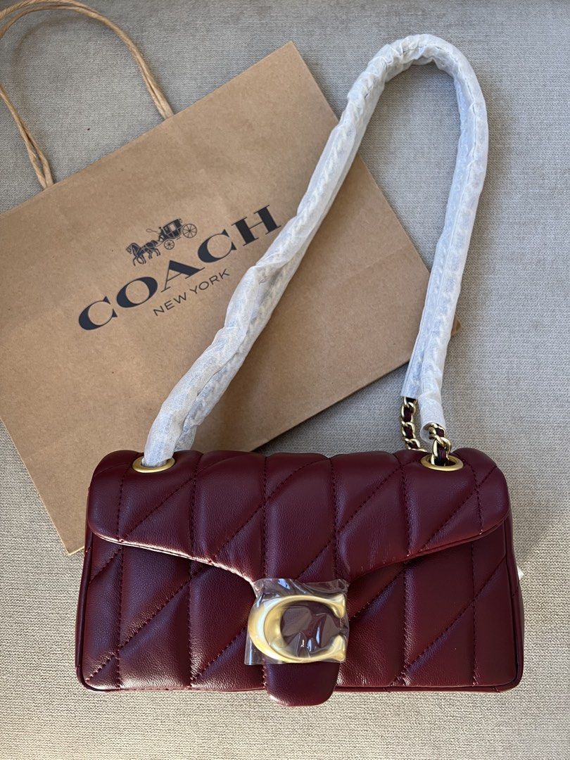 Coach Tabby 20 Quilted (Category: Luxury Bags & Wallets) located in Manila. Submitted by orsaljoce25536 (Listing ID 1469080678, Image 2). Description: - Brand: Coach - Style: Tabby Shoulder Bag - Material: Deep burgundy quilted nappa leather - Hardware: Gold-tone with Signature C (still wrapped in protective plastic) - Strap: Gold-tone chain strap - Interior: Multiple compartments for organization - Condition: Brand new, unused with protective wr