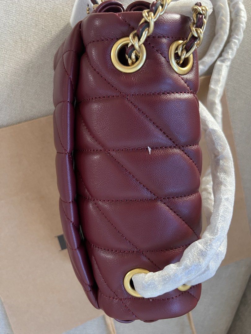 Coach Tabby 20 Quilted (Category: Luxury Bags & Wallets) located in Manila. Submitted by orsaljoce25536 (Listing ID 1469080678, Image 3). Description: - Brand: Coach - Style: Tabby Shoulder Bag - Material: Deep burgundy quilted nappa leather - Hardware: Gold-tone with Signature C (still wrapped in protective plastic) - Strap: Gold-tone chain strap - Interior: Multiple compartments for organization - Condition: Brand new, unused with protective wr