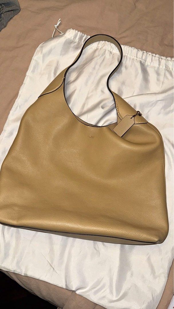 Coach Tan Leather Shoulder Bag Hobo (Category: Luxury Bags & Wallets) located in Pasay City. Submitted by ccpetitte (Listing ID 1469109731, Image 1). Description: - Authentic Coach shoulder bag in classic tan leather - Soft and slouchy silhouette with a comfortable strap - Clean interior lining - Includes original leather hangtag and dust bag - Neutral color that matches any outfit.
