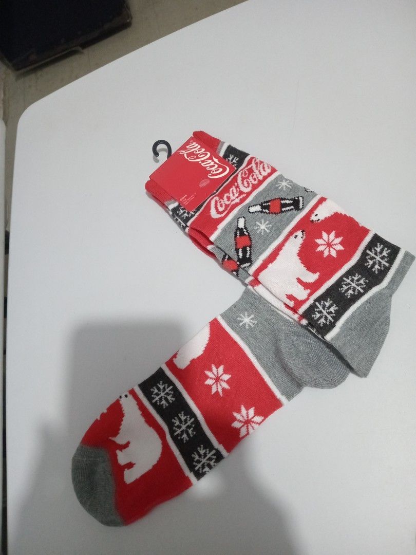 Coca-Cola Holiday Polar Bear Winter Crew Socks (Category: Socks) located in Marikina City. Submitted by joyful.finds (Listing ID 1468956090, Image 1). Description: - Brand new with store tag still attached - Festive Coca-Cola design with iconic polar bears, snowflakes, and classic bottles - Colors: Classic red, white, grey, and black - Made from soft, cozy knit material - Great for keeping warm during winter days.