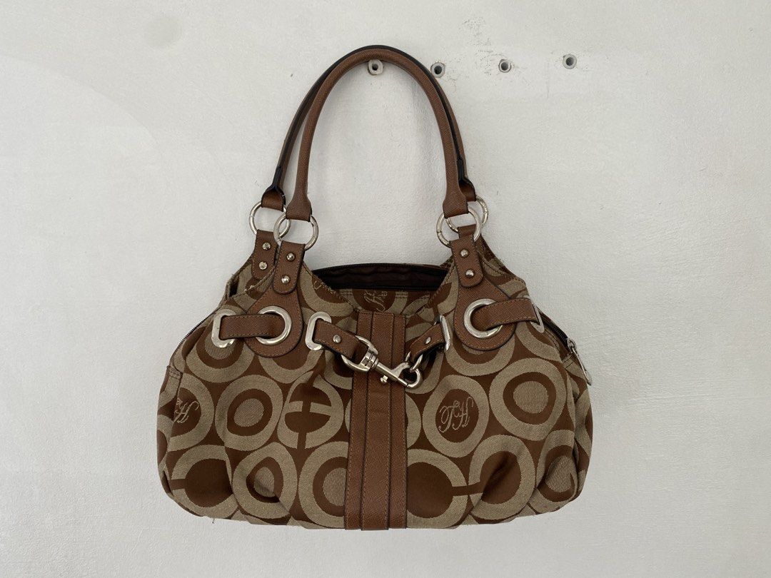 co@ch inspired bag (Category: Shoulder Bags) located in Santa Rosa. Submitted by anghjklica (Listing ID 1469052678, Image 2). Description: Cute brown patterned handbag with ring details and a buckle accent. A stylish vintage-inspired piece perfect for casual outings and everyday use. In good condition! Issue: rusting sa metalware Price: 280+sf.