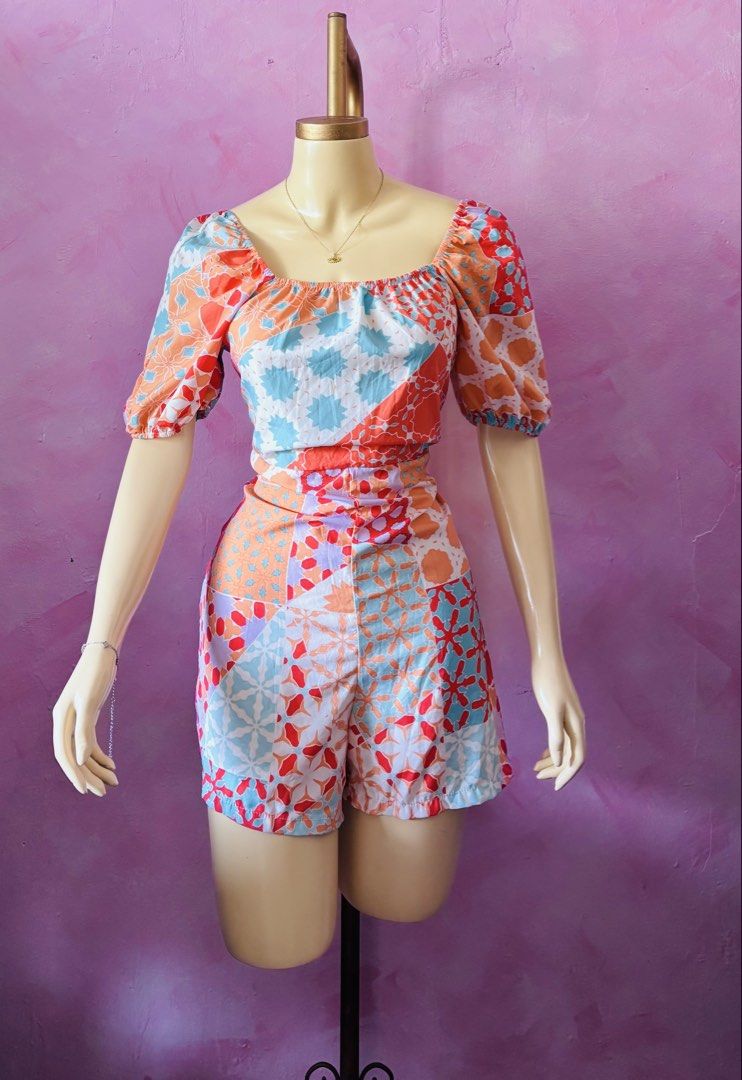 Colorful geometric patchwork square neck romper (Category: Rompers) located in Lipa City. Submitted by classyces24 (Listing ID 1469049363, Image 1). Description: - Vibrant patchwork tile print in orange, blue, red, and purple - Square neckline with comfortable elastic gathering - Fitted waistline with attached shorts for an effortless look - Lightweight and breezy fabric, perfect for hot weather - Easy slip-on style for quick and stylish dressing