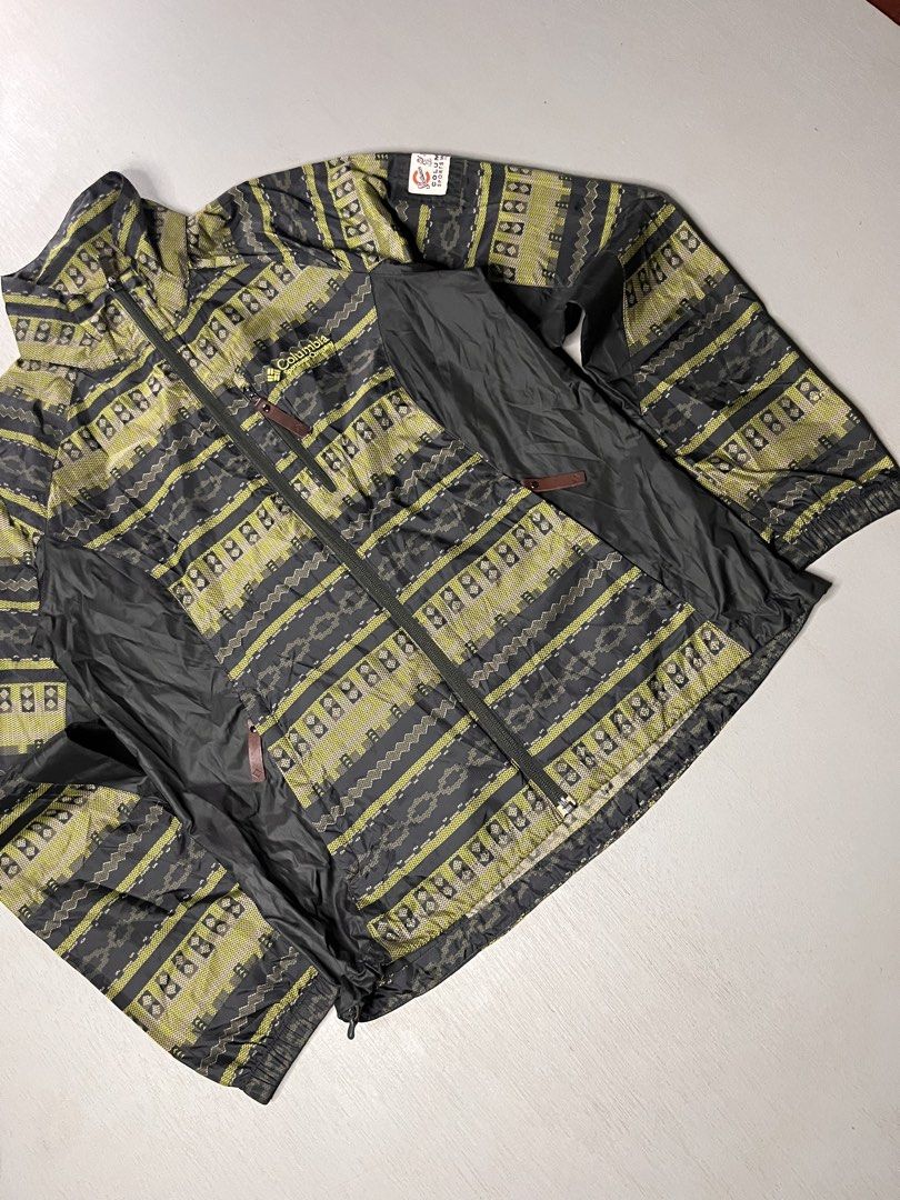 Columbia Sportswear Aztec Pattern Windbreaker Jacket (Category: Coats, Jackets and Outerwear) located in Catbalogan. Submitted by yellfindss (Listing ID 1469132518, Image 3). Description: - Brand: Columbia Sportswear -19/25 - Design: Aztec pattern with contrasting black side panels and retro sleeve patch - Type: Lightweight windbreaker jacket - Features: Full-zip closure, zippered chest pocket, high collar - Condition: Excellent pre-owned conditi