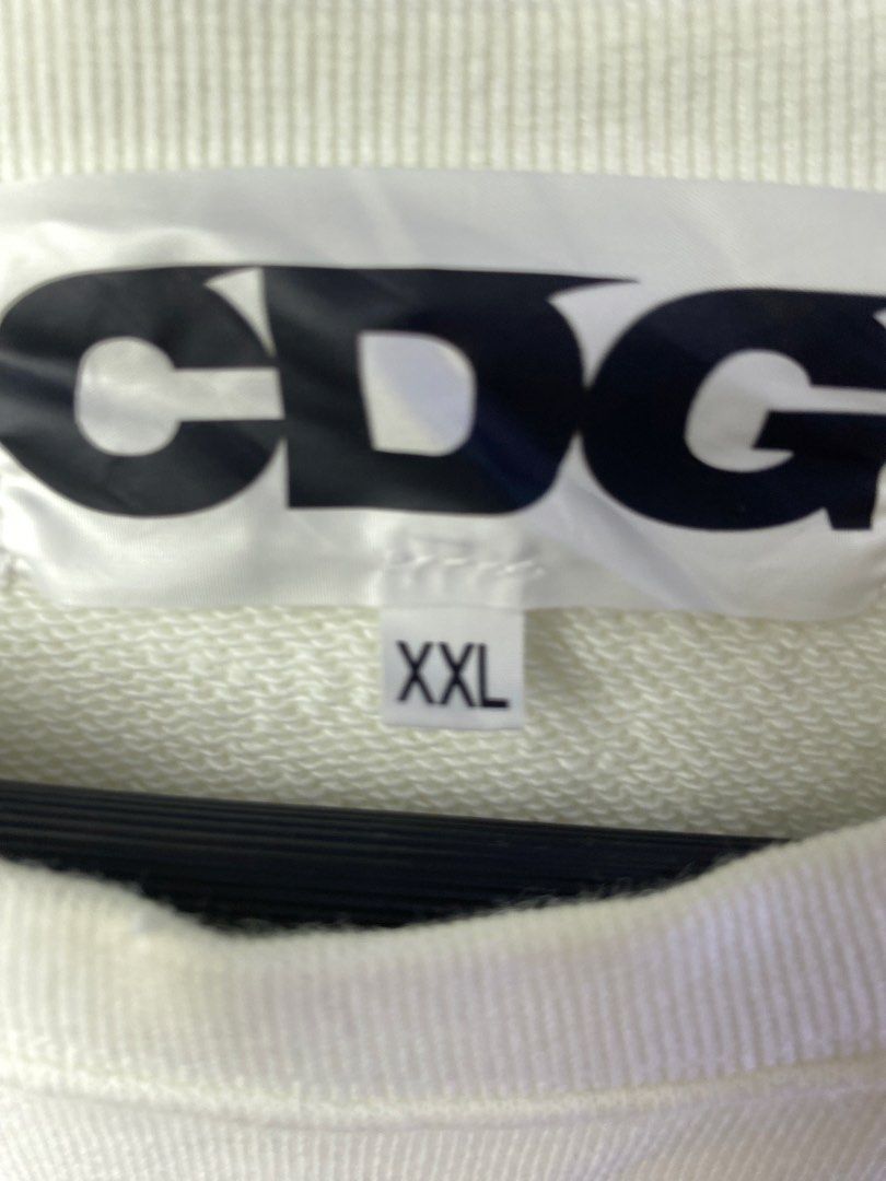 COMME des GARÇONS CDG White Sweatshirt XXL (Category: Coats, Jackets and Outerwear) located in Manila. Submitted by declutterpromax (Listing ID 1468997470, Image 2). Description: - Brand: Comme des Garçons (CDG) - Color: White with bold black back logo and star symbol - Size: XXL - Style: Classic crewneck, ribbed cuffs and hem - Condition: Clean look, easy to style with denim or joggers - Measurements: Provided in the photos.