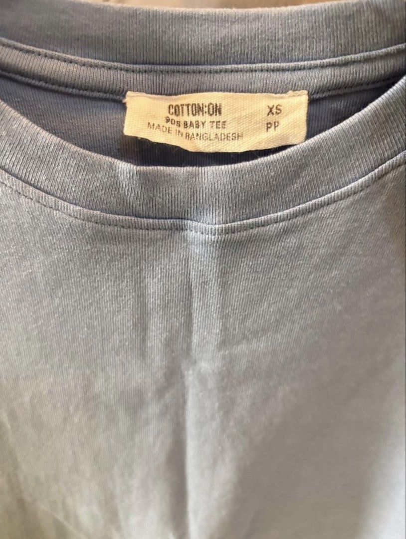 Cotton On baby tee (Category: Shirts) located in Manila. Submitted by inishafaith.g (Listing ID 1469020303, Image 1). Description: AUTHENTIC COTTON ON TOP 🩵 - NEVER BEEN USED - Brand: Cotton On - Size: XS - Color: Light pastel blue - Style: 90s baby tee, crew neckline, short sleeves - Condition: Great basic top for everyday outfits - Origin: Made in Bangladesh.