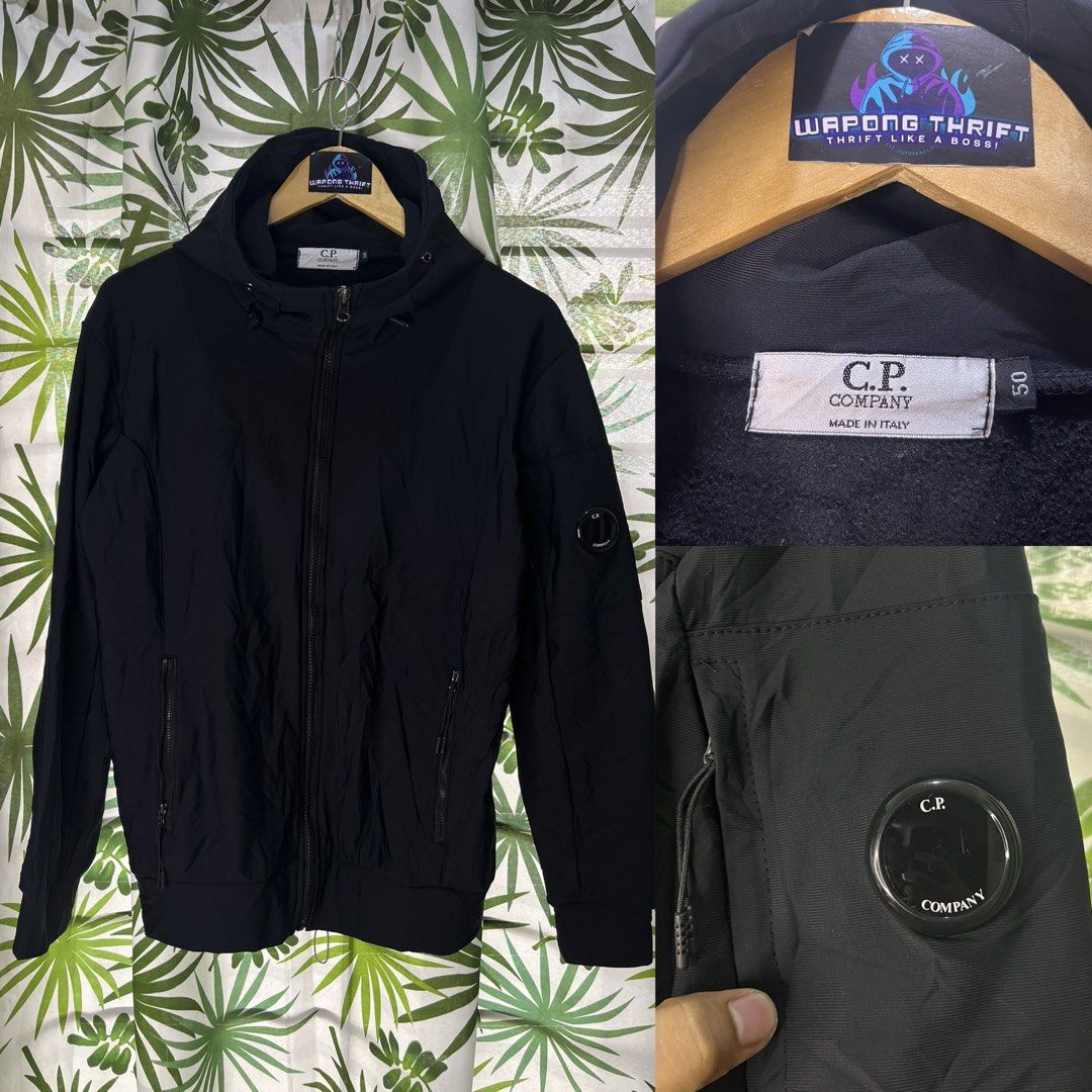 CP company (Category: Coats, Jackets and Outerwear) located in Caloocan City. Submitted by thriftywaps (Listing ID 1468937570, Image 1). Description: - Brand: C.P. Company - Color: Black - Size: 50 (Made in Italy) - Closure: Full zip with dual zipper pulls - Pockets: Two front zipped pockets plus signature sleeve pocket with iconic lens detail - Details: Ribbed cuffs and hem, solid black hardware - Condition: Clean design, perfect as a stylish ev