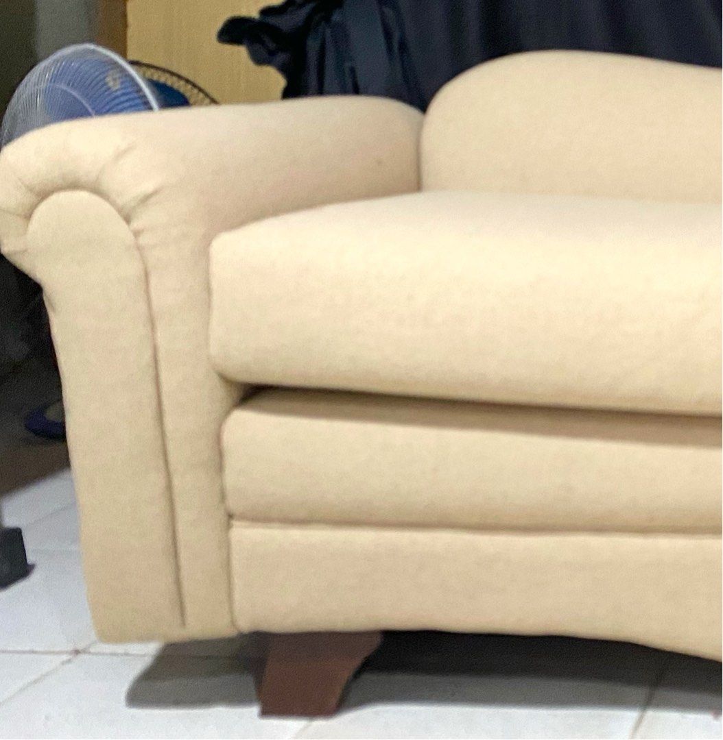Cream Chaise Lounge Sofa with Rolled Arms (Category: Sofas) located in Quezon City. Submitted by agolicu (Listing ID 1469043181, Image 3). Description: - Cream-colored chaise lounge sofa with a stylish asymmetric backrest - Features cozy rolled armrests and deep cushioned seating - Includes a matching throw pillow for extra comfort - Supported by sturdy dark wooden tapered legs - Neutral fabric upholstery that easily blends with any living room d