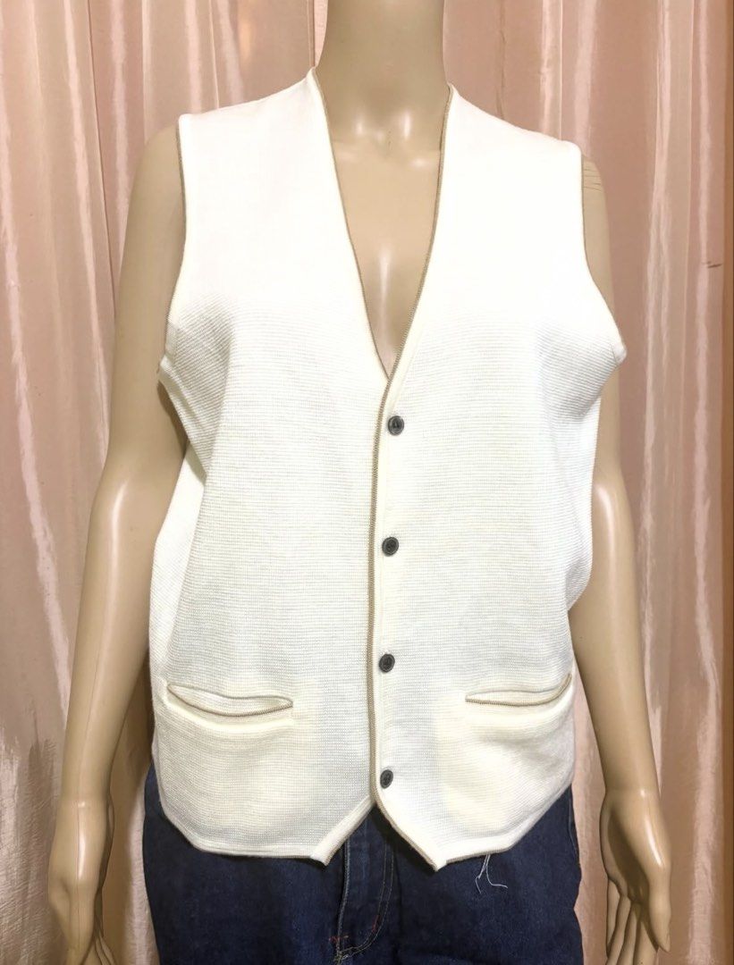 Cream Knit Button-Up Vest with Front Pockets (Category: Sleeveless) located in Cainta. Submitted by tokadore (Listing ID 1468955858, Image 1). Description: - Color: Cream - Style: V-neck knit vest with button-front closure (4 dark buttons) - Features: Two front pockets with contrast piping trim, ribbed texture throughout - Versatility: Perfect for layering over shirts or wearing on its own - Condition: Clean, well-maintained knit fabric.
