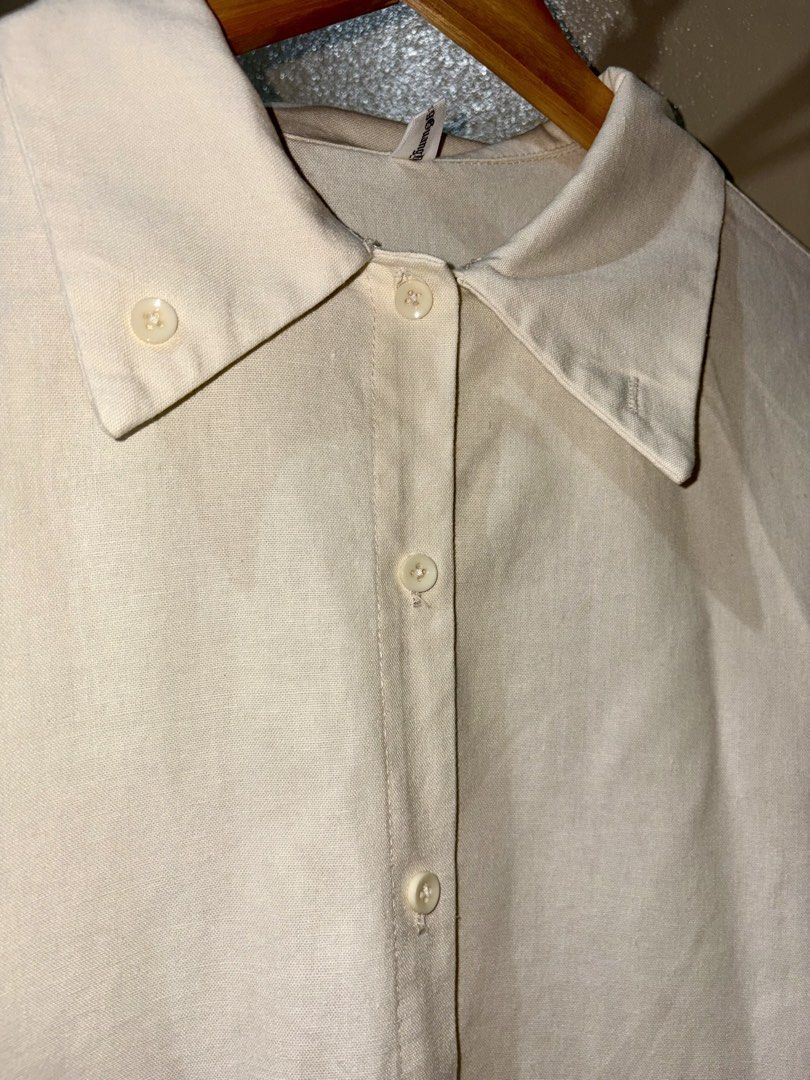 Cream Long Sleeve Button-Up Shirt (Category: Longsleeves) located in Caloocan City. Submitted by stella_mari27 (Listing ID 1469102950, Image 2). Description: - Color: Versatile solid cream neutral tone - Design: Classic collar with front button closure - Details: Structured cuffs and curved hemline - Style: Great for both casual and smart-casual outfits - Condition: Brand new/Mint (Ready to wear).