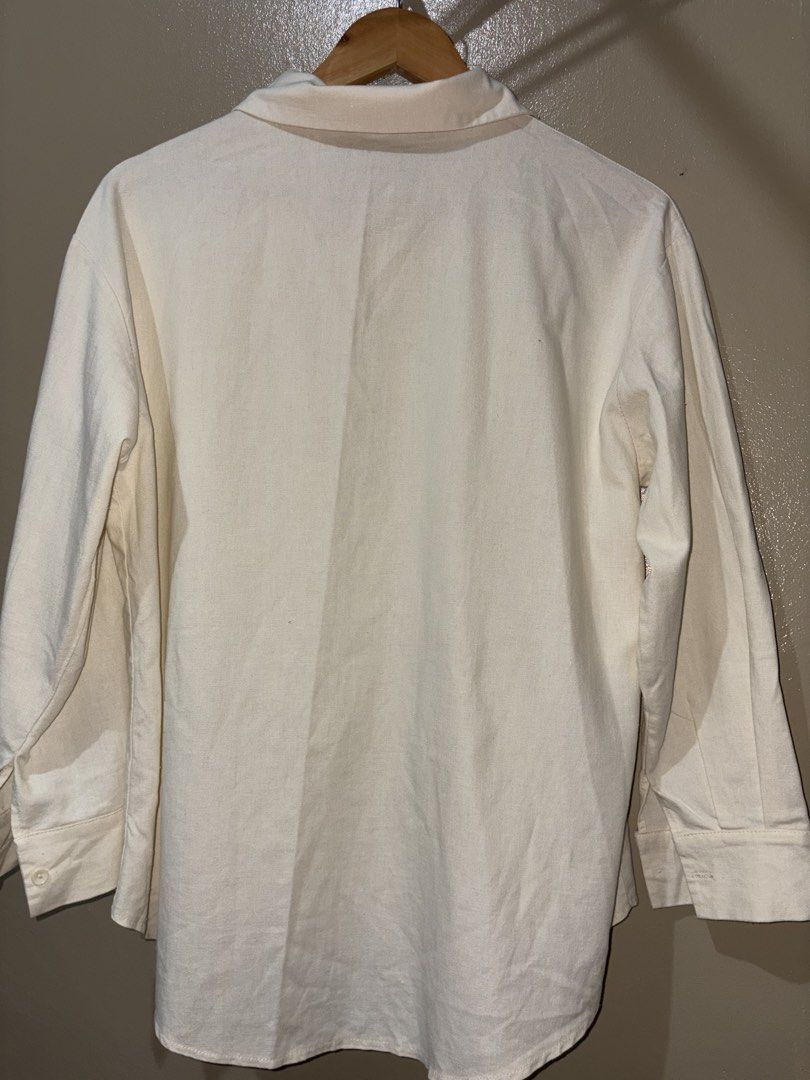 Cream Long Sleeve Button-Up Shirt (Category: Longsleeves) located in Caloocan City. Submitted by stella_mari27 (Listing ID 1469102950, Image 3). Description: - Color: Versatile solid cream neutral tone - Design: Classic collar with front button closure - Details: Structured cuffs and curved hemline - Style: Great for both casual and smart-casual outfits - Condition: Brand new/Mint (Ready to wear).