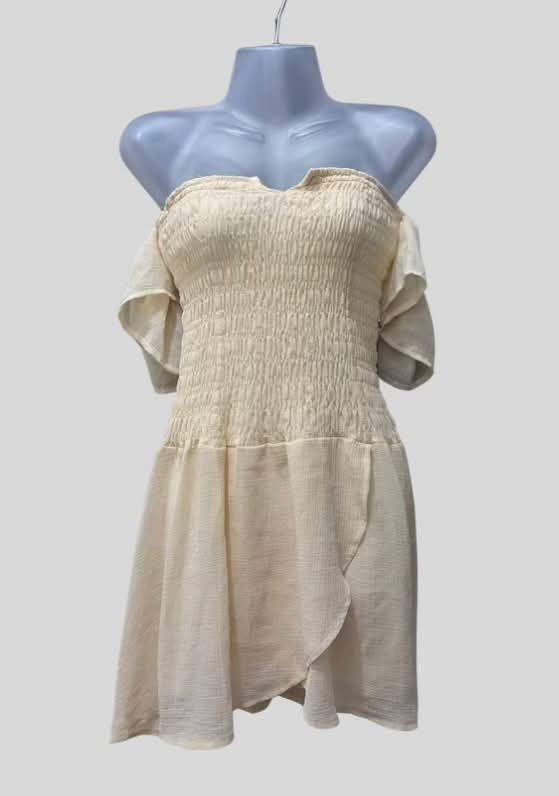Cream Smocked Off-Shoulder Dress (Category: Dresses) located in Manila. Submitted by sisi_jobel (Listing ID 1468988595, Image 1). Description: Cream mini dress featuring a smocked bodice, off-shoulder neckline, flutter sleeves, and a flowy asymmetrical skirt .