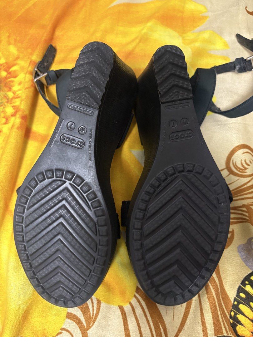 Crocs Black Wedge Sandals Size W7 (Category: Wedges) located in Manila. Submitted by nykji96 (Listing ID 1468980557, Image 3). Description: - Brand: Crocs - Style: Wedge sandals with double strap front - Size: Women's W7 - Closure: Adjustable ankle strap with buckle - Sole: Textured rubber outsole for better grip - Condition: Soles show minimal wear - Ideal for: Casual wear and summer days.
