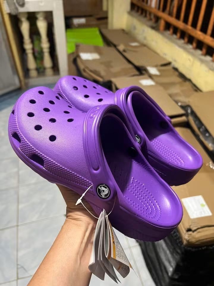 Crocs Classic Clog Purple (Category: Slippers and slides) located in Cebu City. Submitted by madeskartegirl (Listing ID 1468979628, Image 1). Description: size 5-11 available - Item: Classic Crocs Clogs - Color: Bright Purple - Condition: Brand new with original tags still attached - Material: Lightweight foam for all-day comfort - Features: Signature ventilation holes and pivoting heel strap with embossed Crocs logo - Mode of Transaction: Shippi