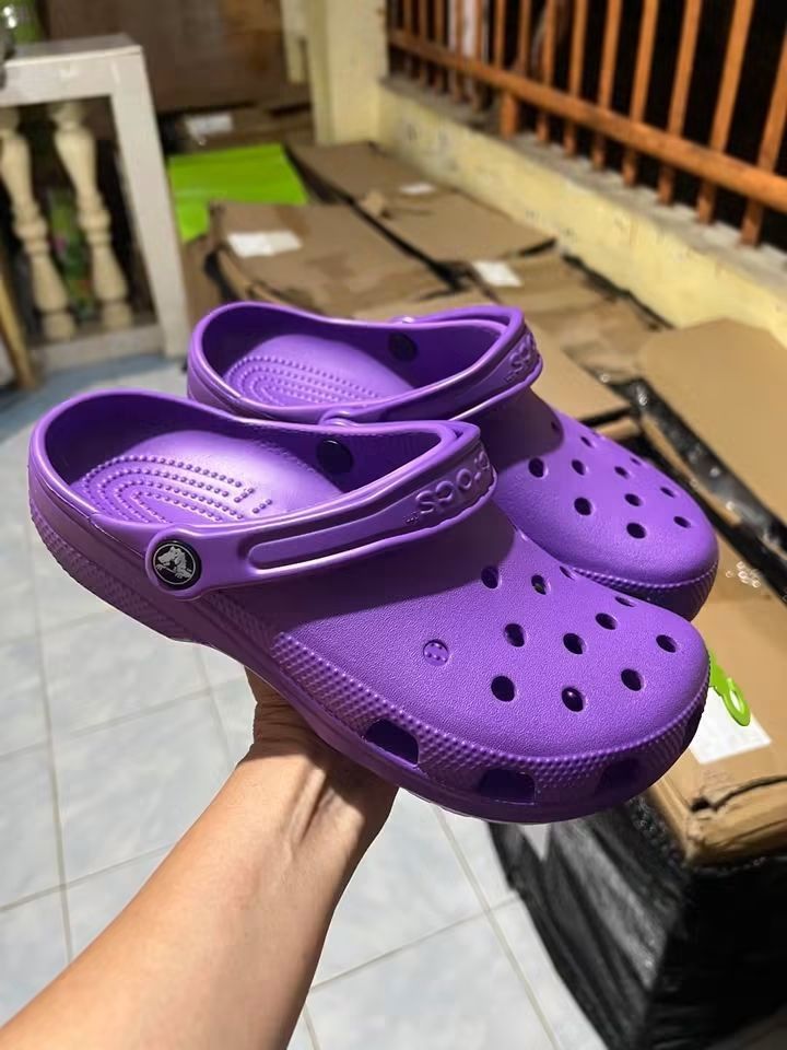 Crocs Classic Clog Purple (Category: Slippers and slides) located in Cebu City. Submitted by madeskartegirl (Listing ID 1468979628, Image 2). Description: size 5-11 available - Item: Classic Crocs Clogs - Color: Bright Purple - Condition: Brand new with original tags still attached - Material: Lightweight foam for all-day comfort - Features: Signature ventilation holes and pivoting heel strap with embossed Crocs logo - Mode of Transaction: Shippi