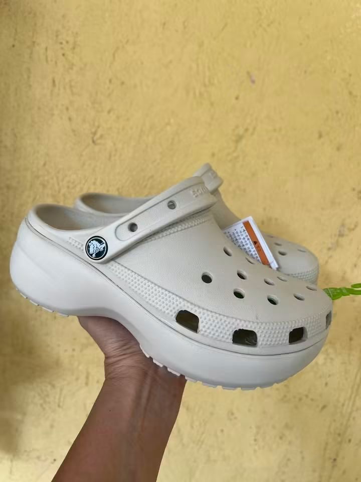 Crocs Classic Crush Clogs Bone (Category: Slippers and slides) located in Cebu City. Submitted by madeskartegirl (Listing ID 1468980630, Image 1). Description: size 5-11 available - Color: Bone white - Style: Chunky platform clogs - Condition: Brand new with original tags attached - Features: Lightweight foam construction, breathable ventilation holes, and pivoting heel strap with metal rivet branding - Perfect for adding height while staying com