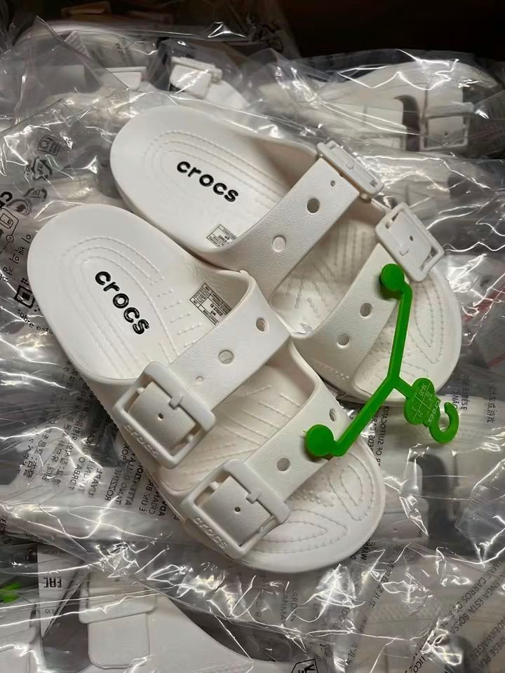 Crocs Classic Two Strap White Sandals Slippers (Category: Flats & Sandals) located in Cebu City. Submitted by madeskartegirl (Listing ID 1468983299, Image 2). Description: Size 5-9 available - Brand new with original store tags and green plastic hanger - Stylish white color with a clean, minimalist design - Double-strap slip-on style featuring two adjustable buckle closures - Textured footbed for enhanced grip and all-day comfort - Ideal for casu