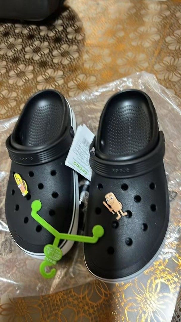 Crocs Clogs Black White with Jibbitz Charms (Category: Slippers and slides) located in Cebu City. Submitted by madeskartegirl (Listing ID 1468980425, Image 2). Description: Size 5-11 available - Brand: Crocs Clogs - Color: Black and White - Condition: Brand new, never worn, pristine condition - Inclusions: Fun Jibbitz charms included, comes with original green plastic hanger tag and original plastic packaging.