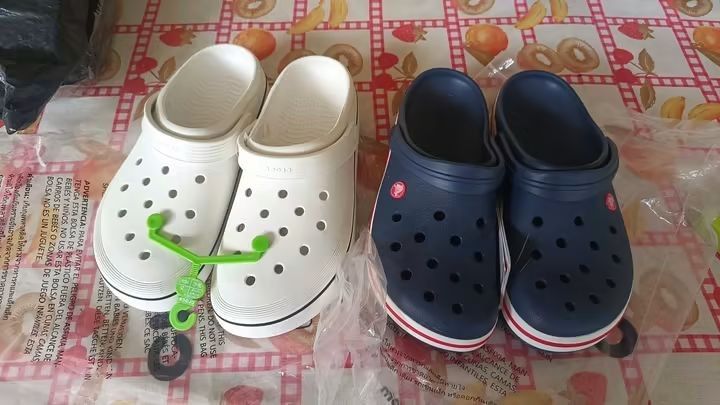 Crocs Clogs with Jibbitz Charms (Category: Slippers and slides) located in Cebu City. Submitted by madeskartegirl (Listing ID 1468977934, Image 2). Description: size 5-11 available - Bundle deal: 2 pairs of Crocs clogs (Navy Blue and White) - Navy pair: Fully decorated with fun Jibbitz charms including SpongeBob, frogs, sports balls, and cartoon characters - White pair: Brand new style featuring an attached green hanger tag - Features: Lightweigh