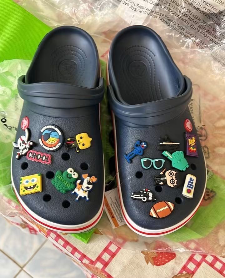 Crocs Clogs with Jibbitz Charms (Category: Slippers and slides) located in Cebu City. Submitted by madeskartegirl (Listing ID 1468977934, Image 1). Description: size 5-11 available - Bundle deal: 2 pairs of Crocs clogs (Navy Blue and White) - Navy pair: Fully decorated with fun Jibbitz charms including SpongeBob, frogs, sports balls, and cartoon characters - White pair: Brand new style featuring an attached green hanger tag - Features: Lightweigh