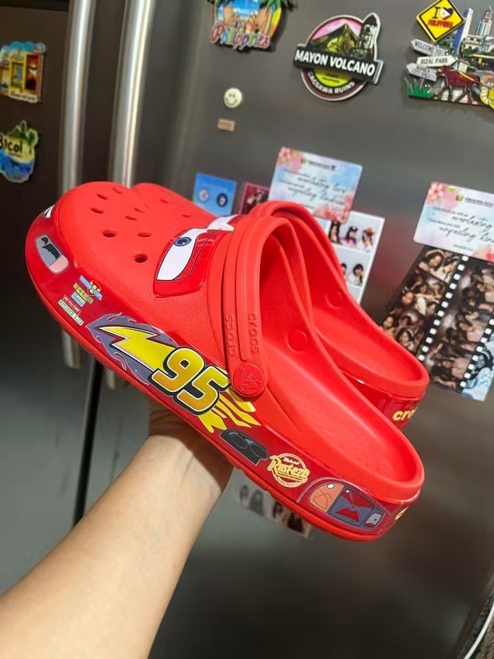 Crocs Disney Pixar Cars Lightning McQueen Clogs (Category: Slippers & Slides) located in Cebu City. Submitted by madeskartegirl (Listing ID 1468980157, Image 2). Description: limited stocks only Brand new with original packaging bags and tag attached - Authentic Lightning McQueen Crocs clogs in bright red - Signature windshield eye graphics on the toe box - Iconic Number 95 and flame graphics printed along the sides - Super fun and comfortable fo