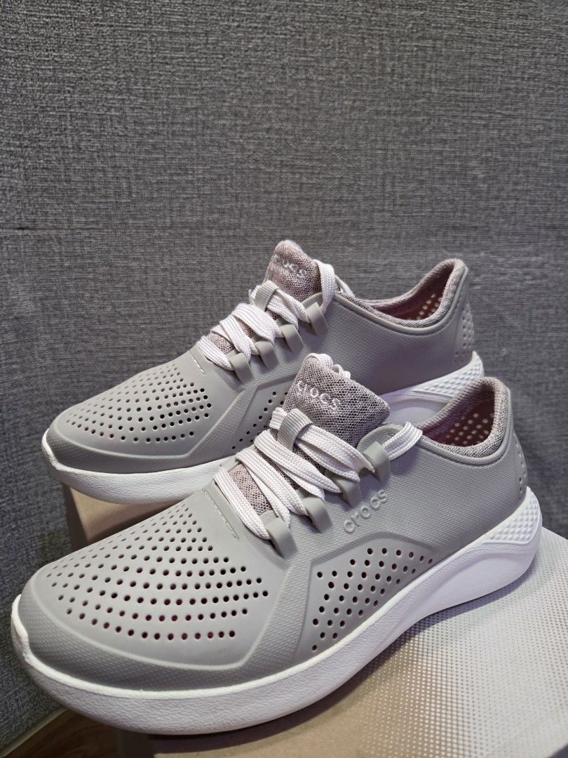 Crocs grey lace-up sneakers (Category: Sneakers) located in Manila. Submitted by isen45 (Listing ID 1469116522, Image 3). Description: - Brand: Crocs 8 womens size - Color: Grey with pink accents - Style: Lightweight slip-on sneakers with laces - Design: Perforated upper for breathability - Soles: Chunky white soles with reliable tread/grip - Interior: Comfortable pink mesh lining - Perfect for: Casual wear, errands, and walking.