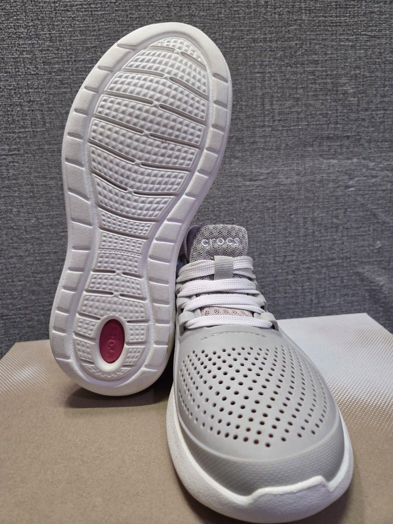 Crocs grey lace-up sneakers (Category: Sneakers) located in Manila. Submitted by isen45 (Listing ID 1469116522, Image 2). Description: - Brand: Crocs 8 womens size - Color: Grey with pink accents - Style: Lightweight slip-on sneakers with laces - Design: Perforated upper for breathability - Soles: Chunky white soles with reliable tread/grip - Interior: Comfortable pink mesh lining - Perfect for: Casual wear, errands, and walking.