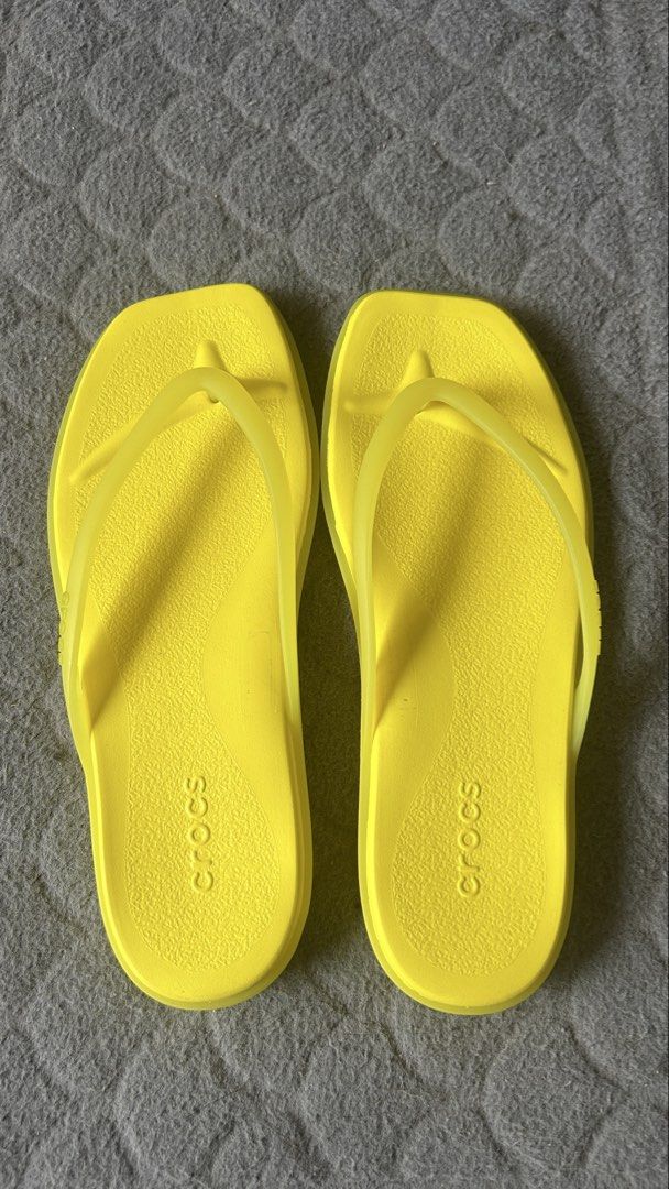 Crocs Yellow Flip Flops Size W5 (Category: Slippers and slides) located in Paranaque City. Submitted by jesseygirl83 (Listing ID 1468973472, Image 1). Description: - Brand: Crocs - Style: Flip flops / thong strap - Color: Bright yellow - Size: Women's US 5 - Features: Lightweight foam construction, textured footbed, grooved rubber soles - Ideal for: Summer beach trips, pool days, or everyday casual wear - Never used just stored inside the shoe ca