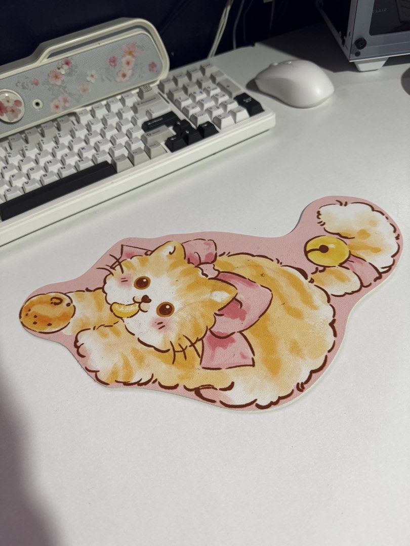 Cute cat mousepad pink orange fluffy kitten desk mat (Category: Mouse & Mousepads) located in Penaranda. Submitted by deardarlaph_ (Listing ID 1468935567, Image 1). Description: - Adorable orange and white cat design with a cute pink bow - Soft surface featuring a lovely watercolor illustration style - Non-slip white rubber backing keeps it firmly in place - Measures approximately 27cm across - Perfect for adding a cheerful touch to your desk set